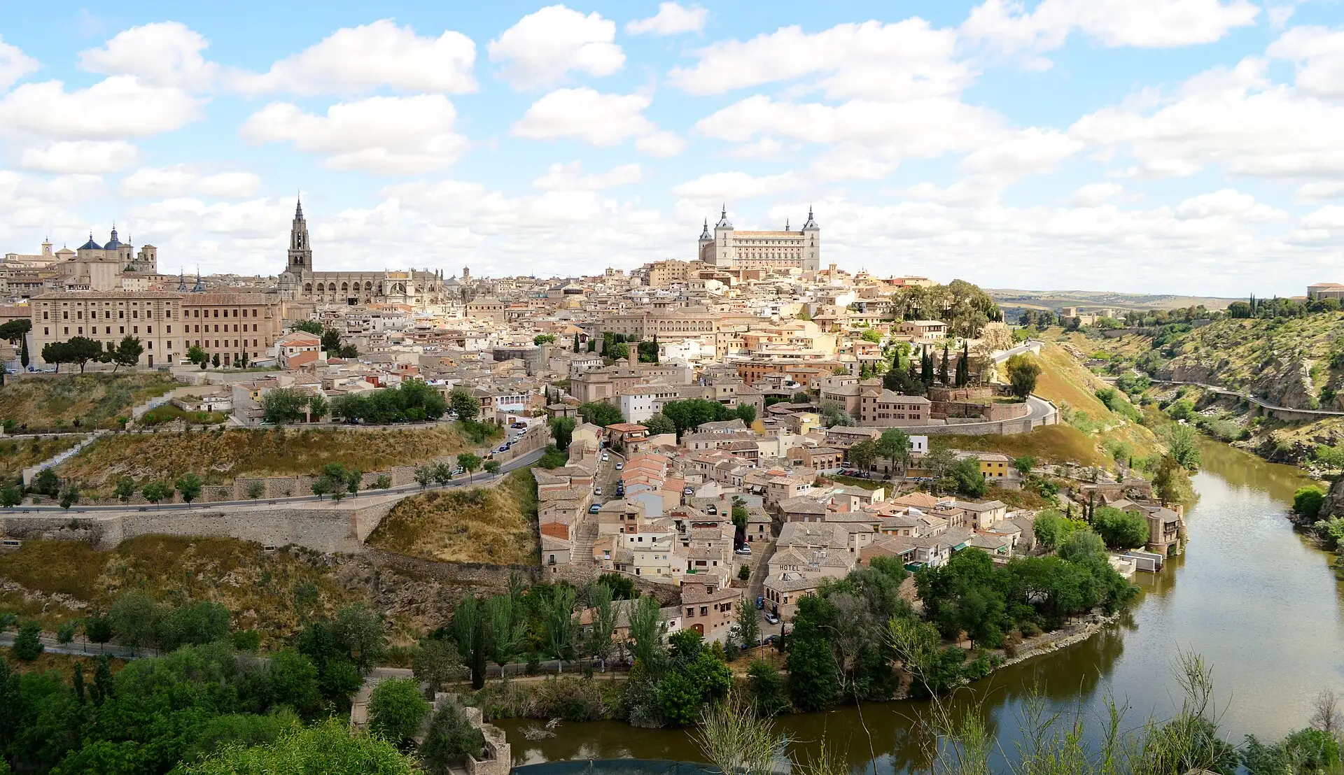 Toledo on its hill above a bend of the Tagus, with the cathedral spire and the Alcázar